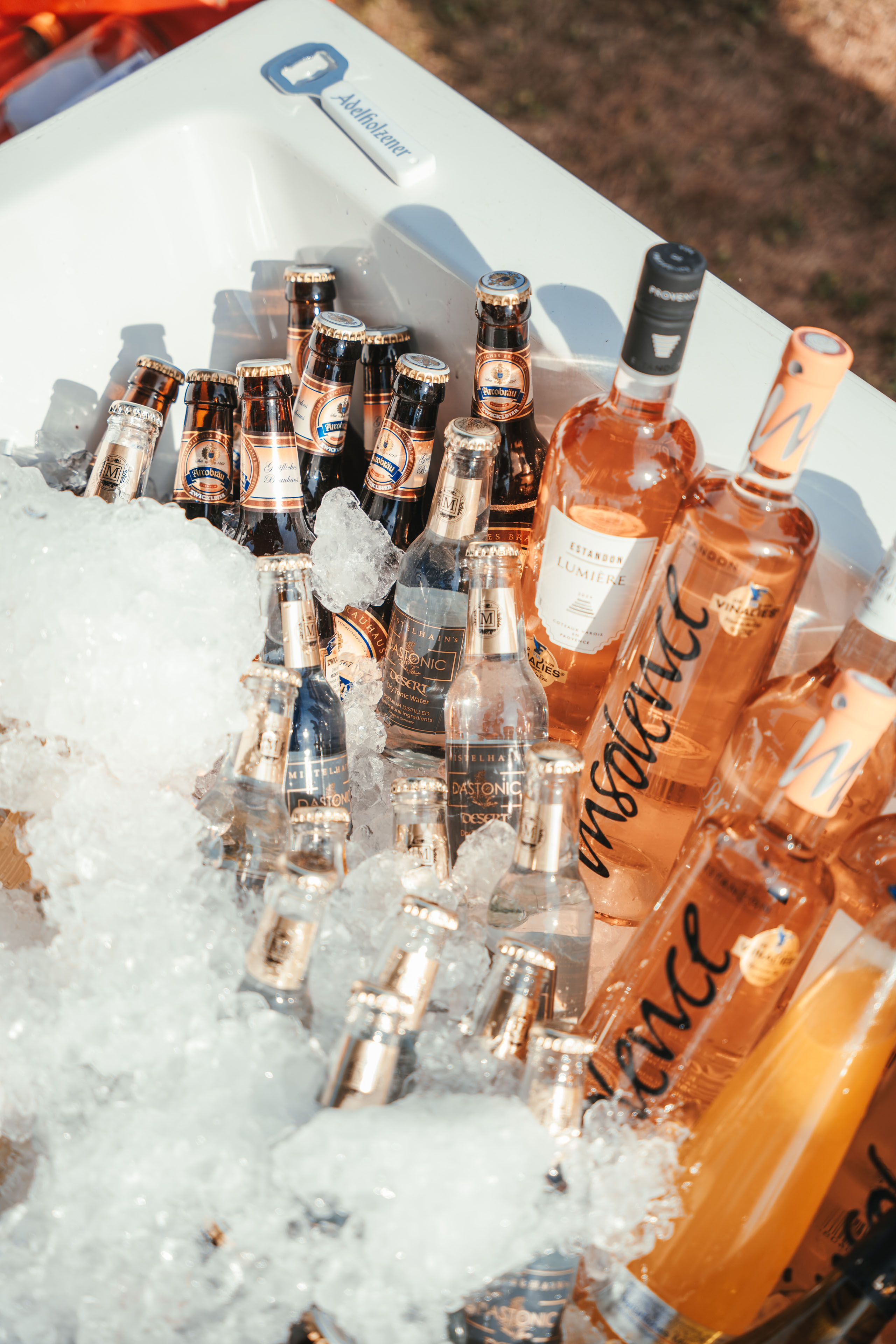 Various bottles of beer and beverages chilled in an ice bucket