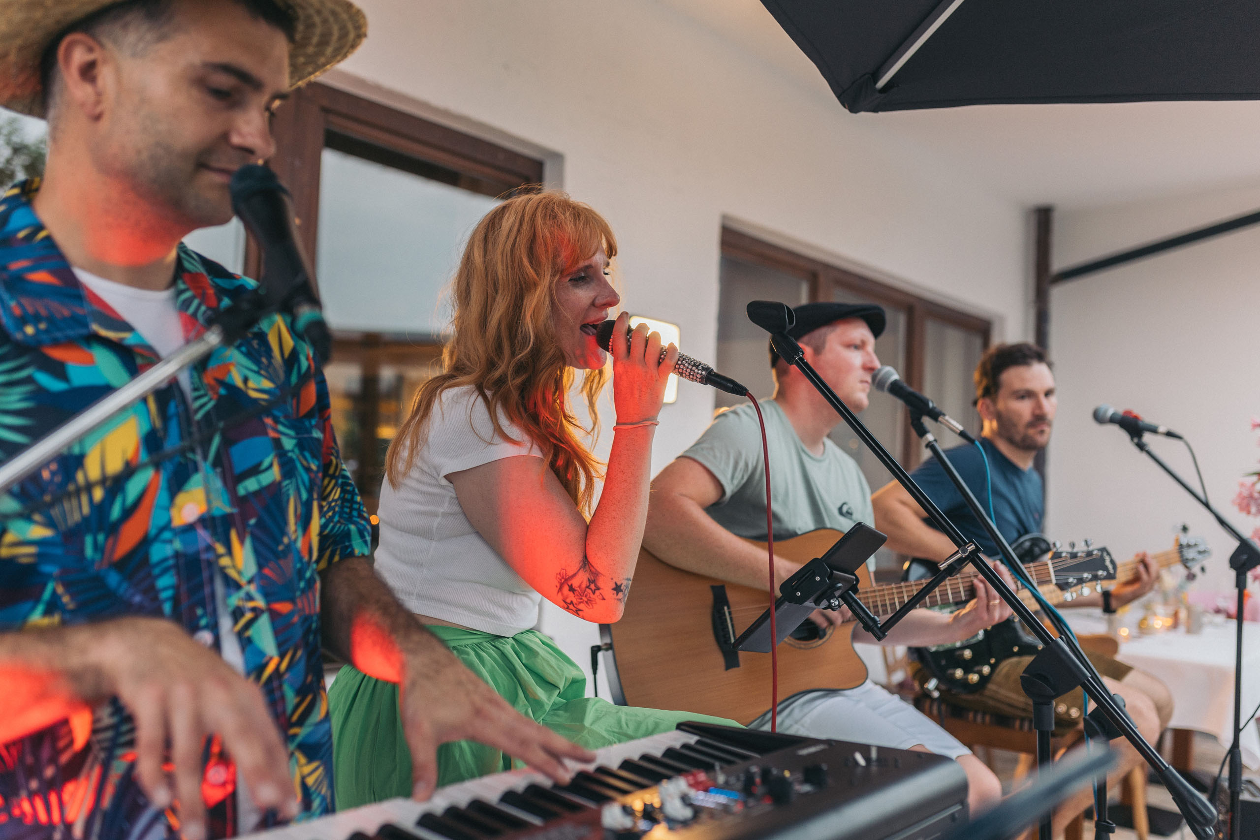 Band with singer, keyboardist and two guitarists performing live